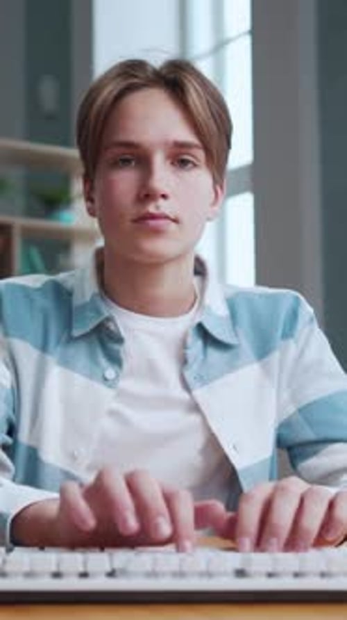 Portrait of Young Boy Typing on Keyboard of Computer Pc and Studying Online