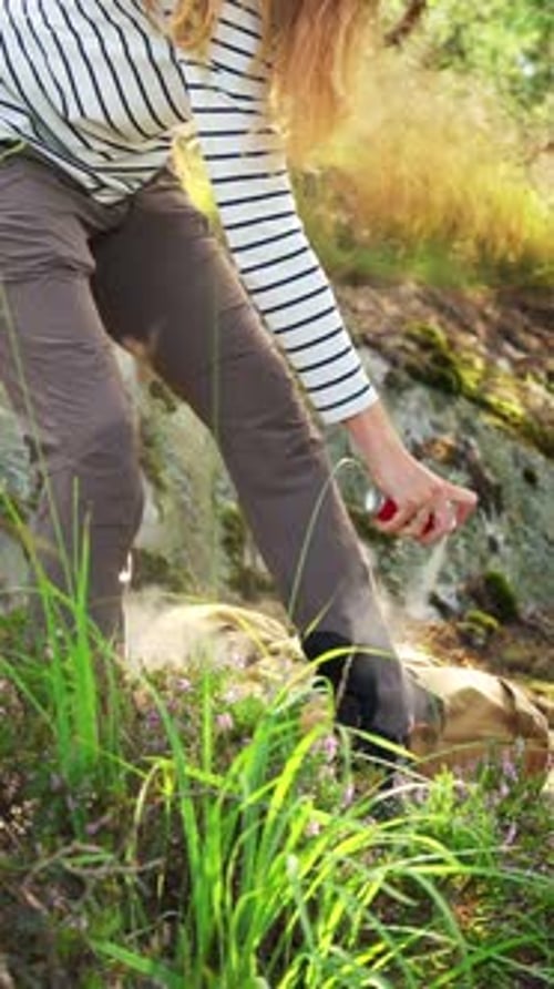 Woman Sprays Herself with Insect Repellent in Nature