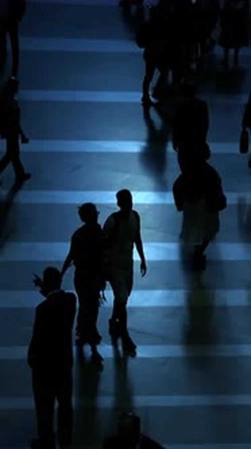 Silhouettes of People Walking in City at Night