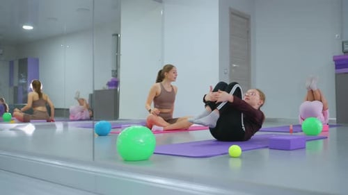 Children's Fitness Class with Instructor Supervision in Reflective Gym