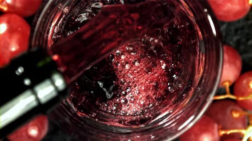 Red Wine is Poured Into a Glass Top View Filmed on a Highspeed Camera at 1000 Fps