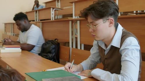 Young Asian Student Making Notes