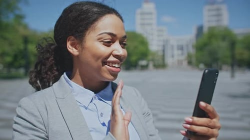 Business Woman Video Chatting on Smartphone in City