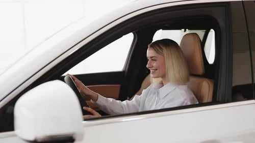 Happy Woman Smiling Holding Car Keys in Car