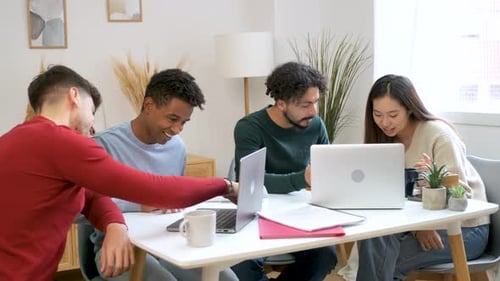 Group of University Colleagues Studying Together at Shared Students House