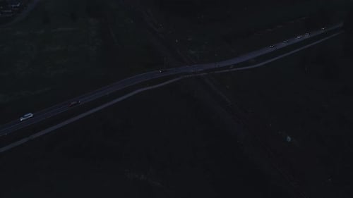 An Aerial View of a Night Roadway Scene Showing Sparse Vehicle Traffic Creating a Serene Nighttime