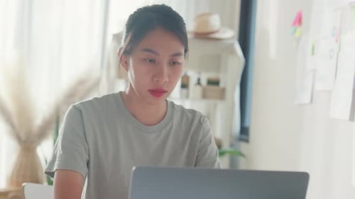 Close-up Young Asia girl IT development programmer typing on keyboard coding programming fixing data