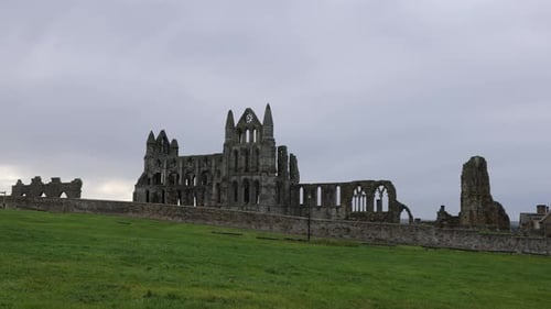 Static shot of the famous Whitby Abbey ruins remaining in Yorkshire on a cloudy day