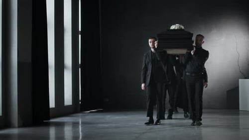 Men and Women Carry Casket into Room