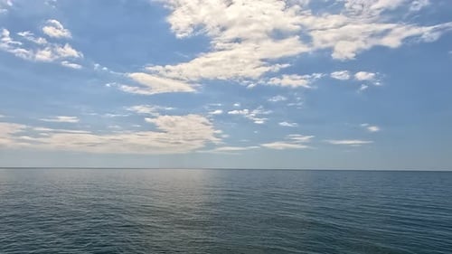 Sea Water Surface Aerial View on Calm Water Surface Camera Flies Over Clear Sea Ocean Sun Glare