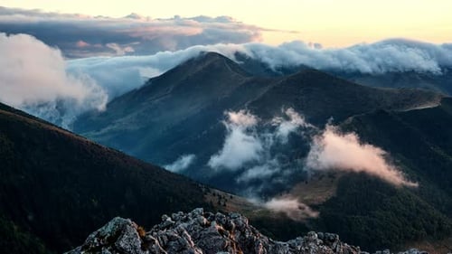 Mountain Range Covered in Clouds at Sunrise
