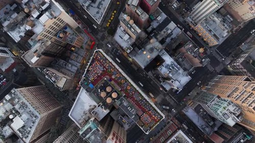 Bird's Eye Views Capture Cars and Yellow Taxi Cabs Navigating a Bustling Manhattan's Intersection in