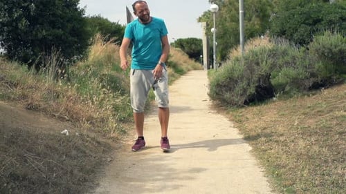 Tired Male Jogger Resting After Run In Park, Super Slow Motion 240fps