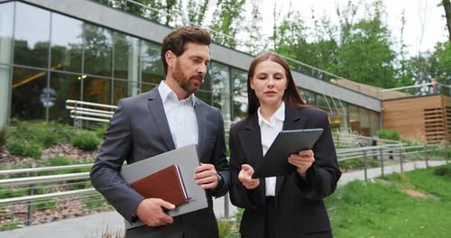 Portrait of Two Business People a Man and a Woman in Formal Attire Standing Outside a Modern Office