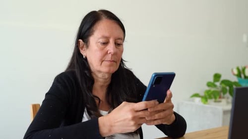 An Adult Woman Typing A Message Using An Android Cellphone. Medium Closeup Shot