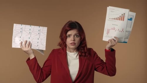 Woman Displaying Charts with a Frustrated Expression