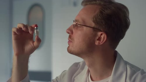 Doctor Examines Vial in Office Medical Setting