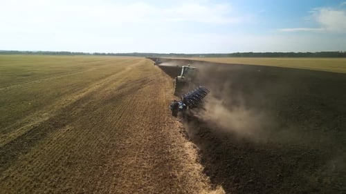Tractors plowing the field in Ukraine