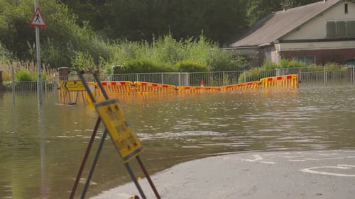 Flooded Roundabout with Yellow Diverted Traffic Signs with Road Underwater from Flash Flood