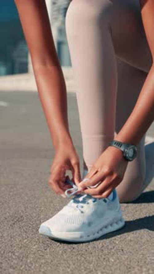 Hands, runner and tie shoes in road to start exercise, running preparation