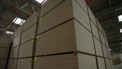 Piles of manufactured wood boards in warehouse