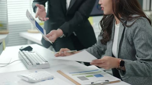 businesspeople working and brainstorming in office