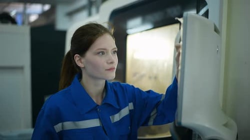 Female Robotics engineers Using Controller to Remotely Operate programming