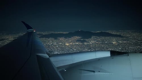 Airplane Coming in for Landing with View From Porthole Window at Night
