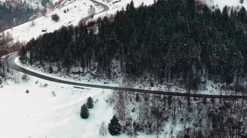 Aerial view of winding mountain road in winter