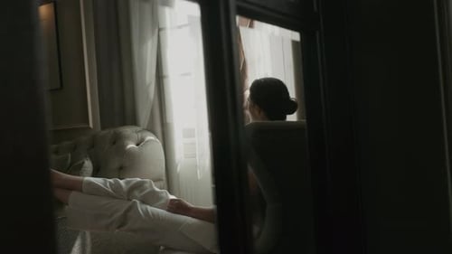 Woman Relaxing in Sunlight in Elegant Room