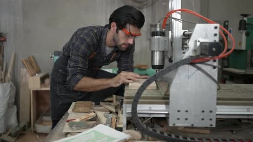Carpenter is working at workshop.