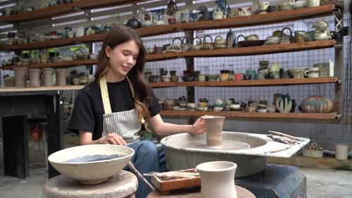 People Creating Pottery in Studio. Female artisan creating handmade ceramics in pottery workshop