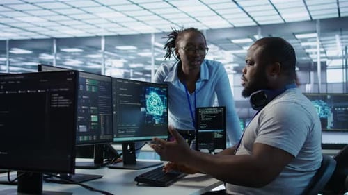 Developers Discussing Code in Modern Office