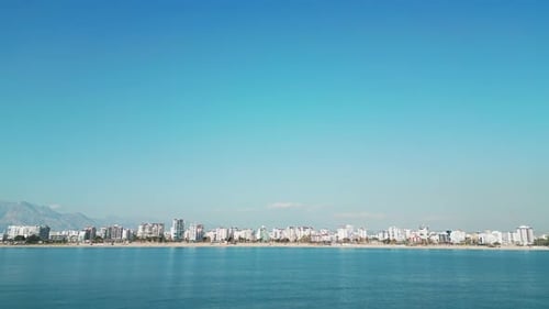 The Camera Flies Up or a View From a Ship Approaching the Coast of a Southern City