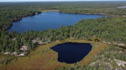 Aerial: pristine lakes amidst dense forest, Killarney Park, Canada