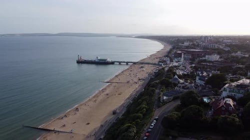 Aerial Descending Bournemouth Pier and Beach Golden Hour Sunset