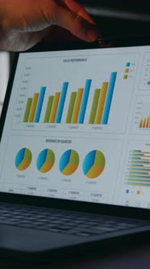 CloseUp of Laptop Screen Displaying Yellow and Blue Data Charts