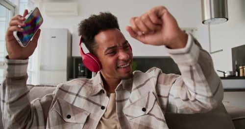 Man Singing Along to Music on Smartphone