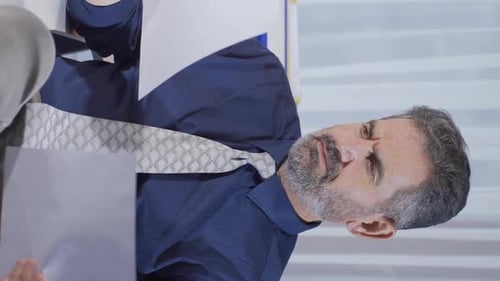 Man Reviews Documents in Office Setting