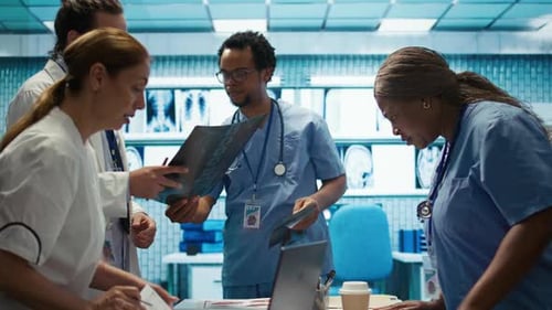 Medical Team Examining X-Rays in Hospital Room
