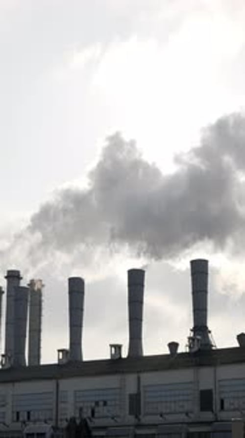 Smokestacks of Factory Emitting Smoke into Sky