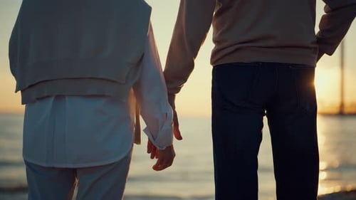 Romantic Couple Holding Hands on a Beach
