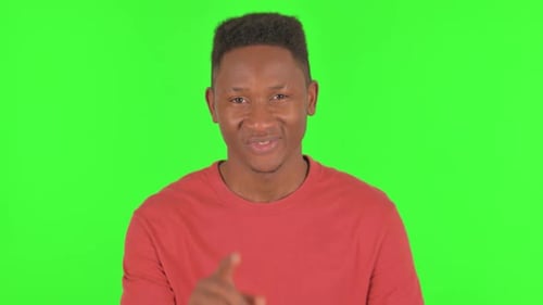 Portrait d'un homme africain invitant des gens sur fond vert