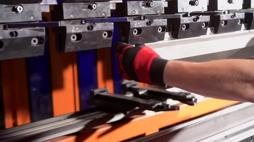 Metalworking Professional Worker Folding Piece of Metal Element Using Powerful Automatic Metal Bendi