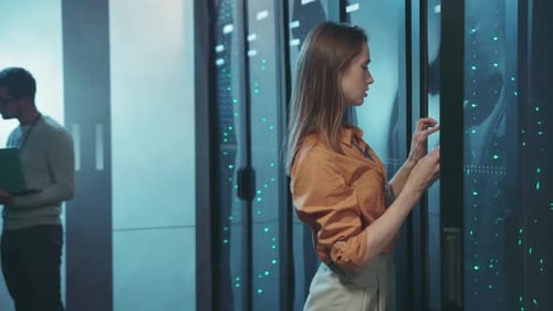 A Highly Skilled and Professional Female Technician Operating in a Data Center Environment