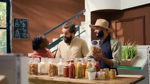 Three Adults in Grocery Store Talking at Counter