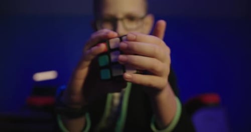 Concentrated Child Solving Colorful Puzzle Cube