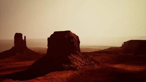 Aerial View of a Massive Rock Formation Standing Proudly in the Desert