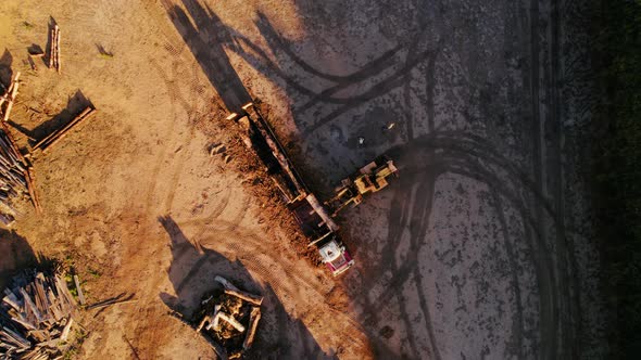 Aerial View of a Logging Truck Loading Logs in a Field at Sunset ...