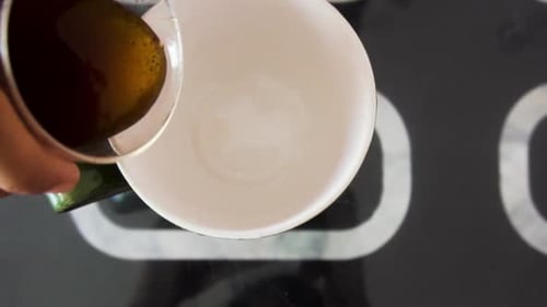 Coffee Being Poured Into a White Cup